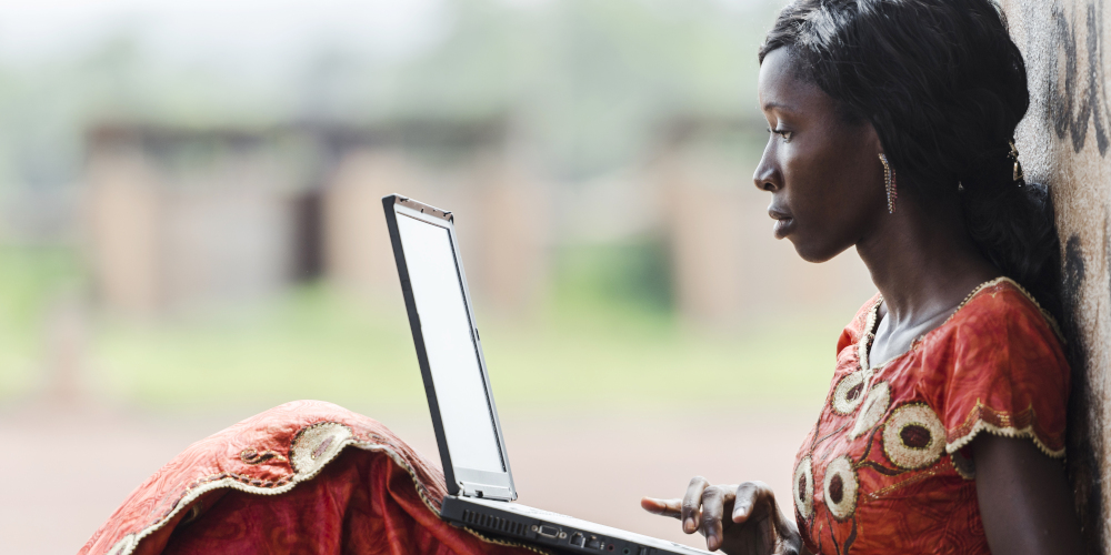 Picture showing a woman using a laptop outdoors