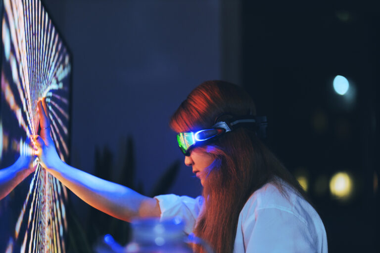Decorative image for network APIs, young woman wearing augmented reality glasses touching screen with hands